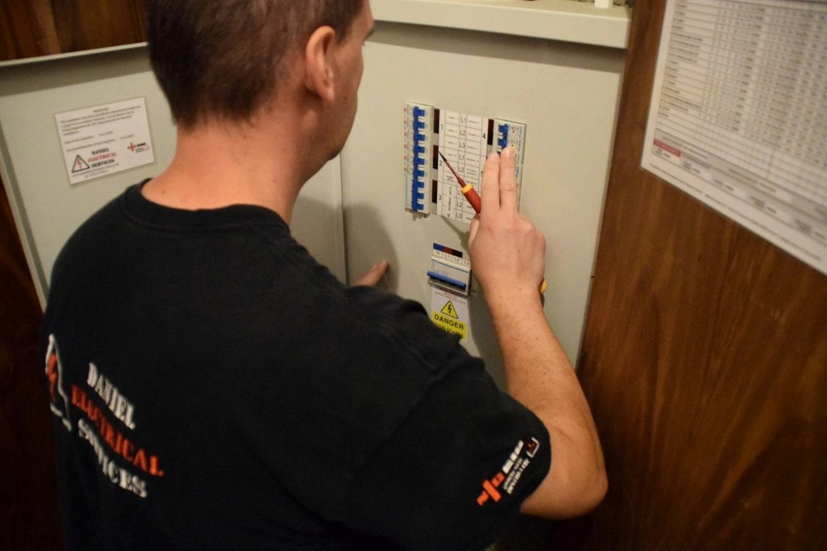 A Daniel Electrical electrician testing a consumer unit