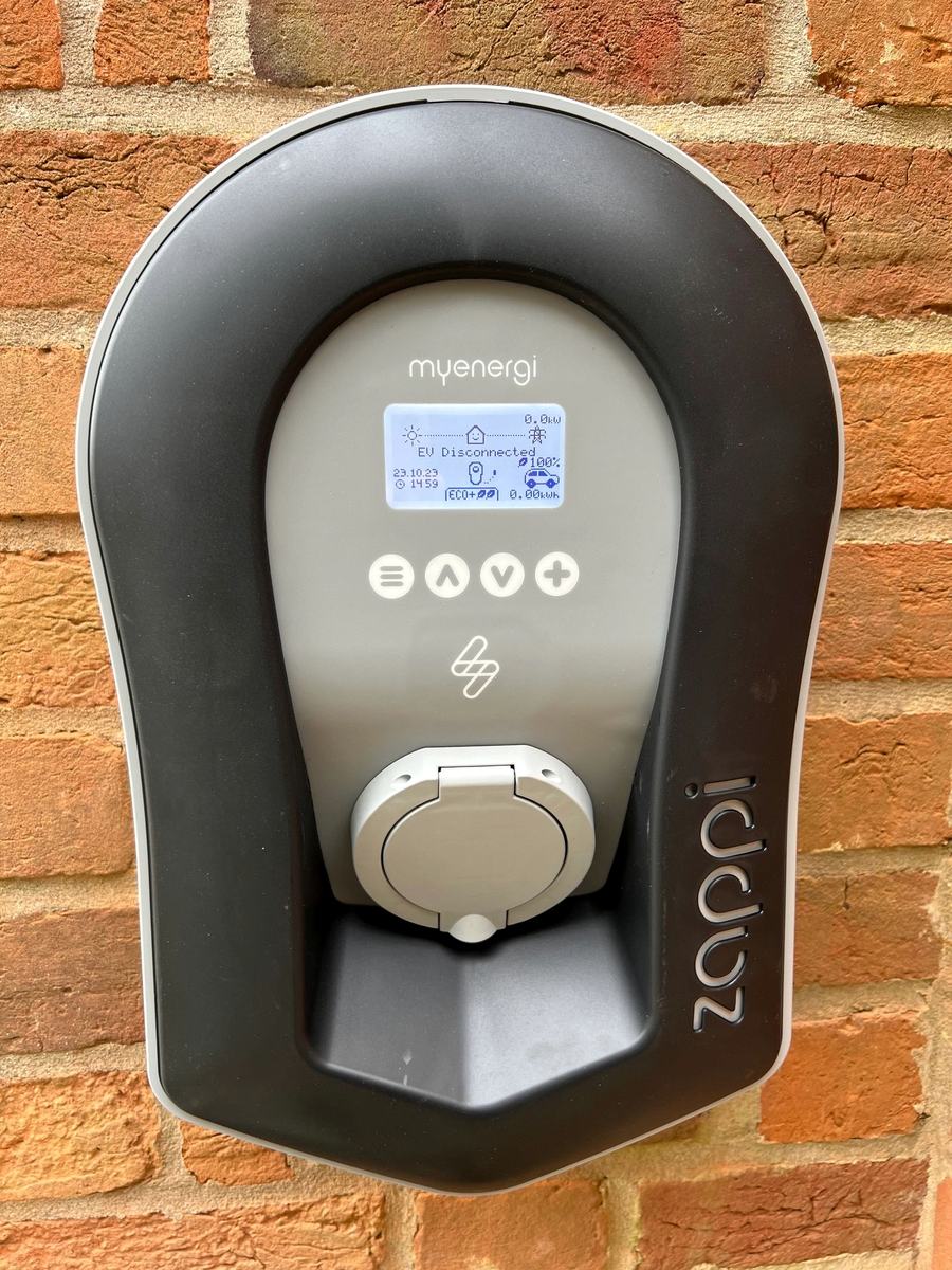 Zappi EV charger fitted on a brick wall